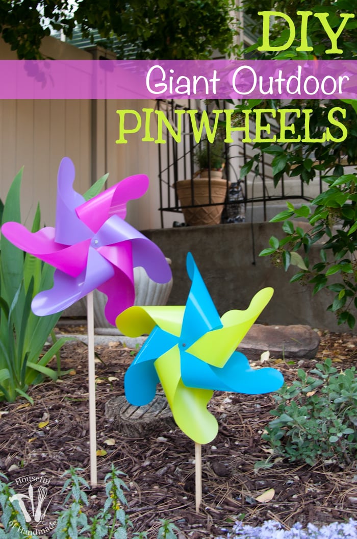 How fun are these pinwheels? These DIY Giant Outdoor pinwheels are made from plastic so they can withstand the weather. Perfect outdoor decor for your flower garden. | Housefulofhandmade.com