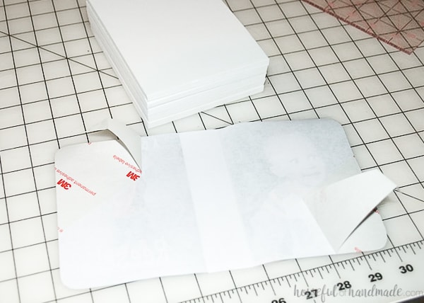 The back of the cover piece with the label backing peeled off and the extra piece cut to cover the inside of the spine area.