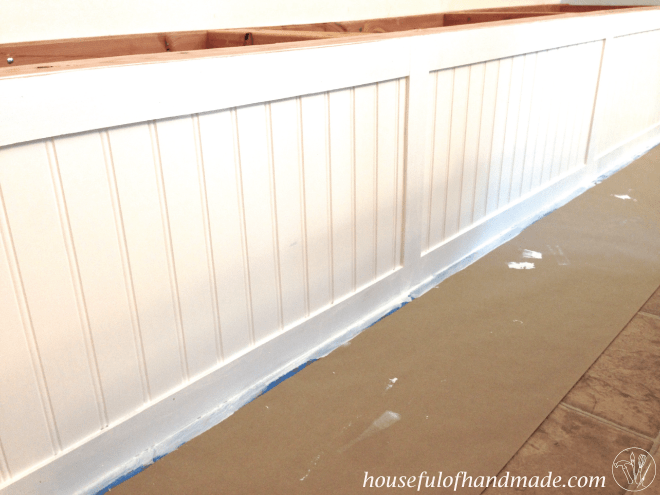 Paint is applied to the dining bench with storage.