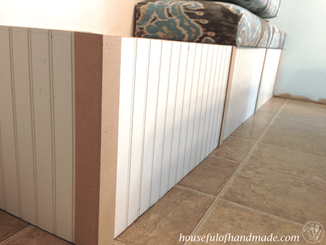 Long view of multiple pieces of trim on the diy dining bench with storage.