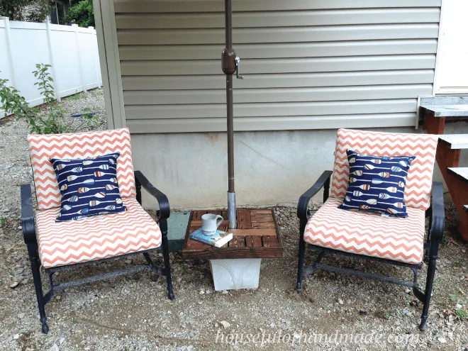 set of two patio chairs shown with diy umbrella stand with side table 