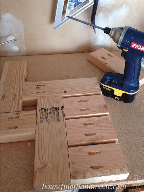 pieces of wood cut and screwed together for base of diy umbrella patio side table with ryobi drill