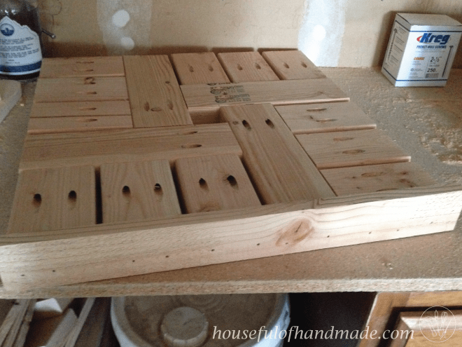 diy umbrella stand side table top shown on work bench prior to staining 