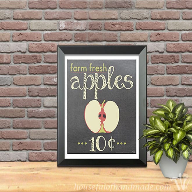 Farm fresh apples 10 cents sign in a black frame in front of a brick wall. 