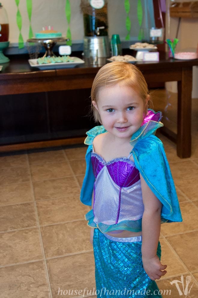 Toddler in a mermaid costume during her little mermaid birthday party.