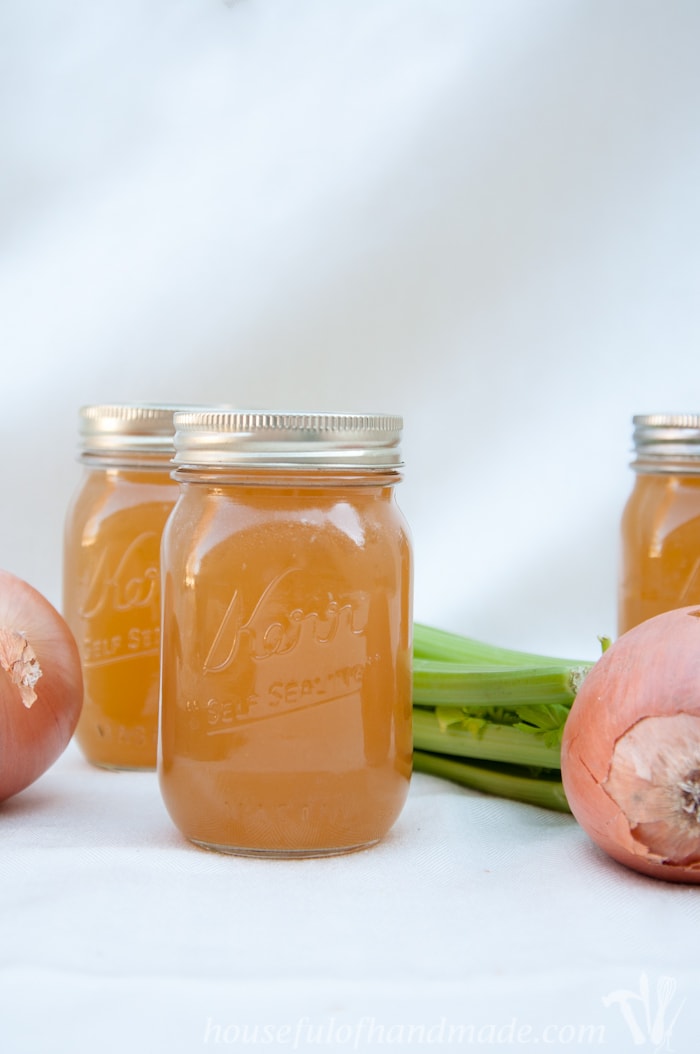 Learn how to make and preserve chicken stock for only pennies. Seriously, it takes just scraps to make a large pot of delicious stock for all your soup cravings this winter. | Housefulofhandmade.com