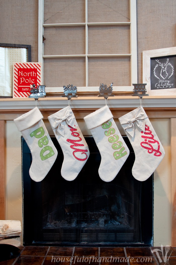DIY Personalized Christmas stockings hanging on fireplace mantel.
