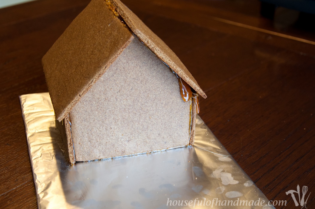 Don't let frustration over putting together gingerbread houses keep you from making traditions with your family. Use "Hot Glue" to put it together instead! This tutorial shows you how to easily assemble a gingerbread house with melted sugar. | Housefulofhandmade.com