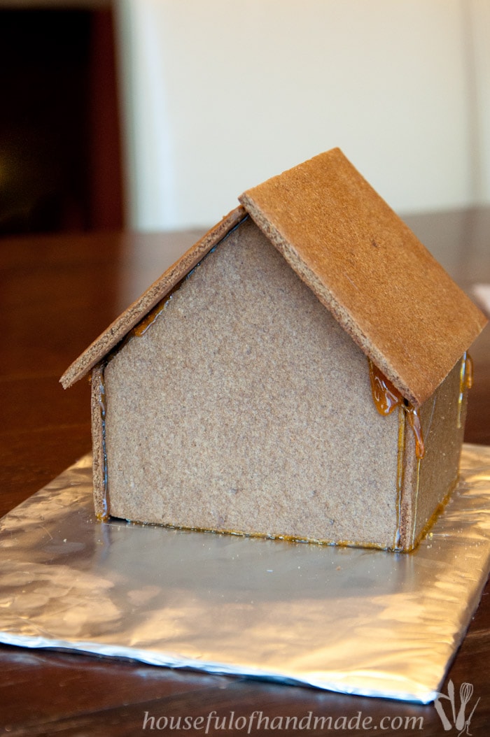 Don't let frustration over putting together gingerbread houses keep you from making traditions with your family. Use "Hot Glue" to put it together instead! This tutorial shows you how to easily assemble a gingerbread house with melted sugar. | Housefulofhandmade.com