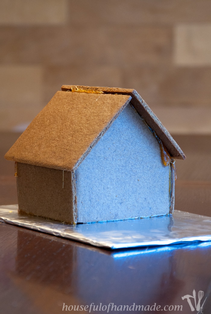 Don't let frustration over putting together gingerbread houses keep you from making traditions with your family. Use "Hot Glue" to put it together instead! This tutorial shows you how to easily assemble a gingerbread house with melted sugar. | Housefulofhandmade.com