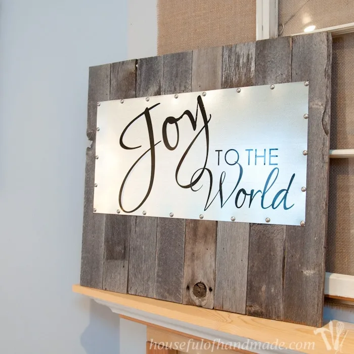 reclaimed wood and steel Christmas sign standing on mantel