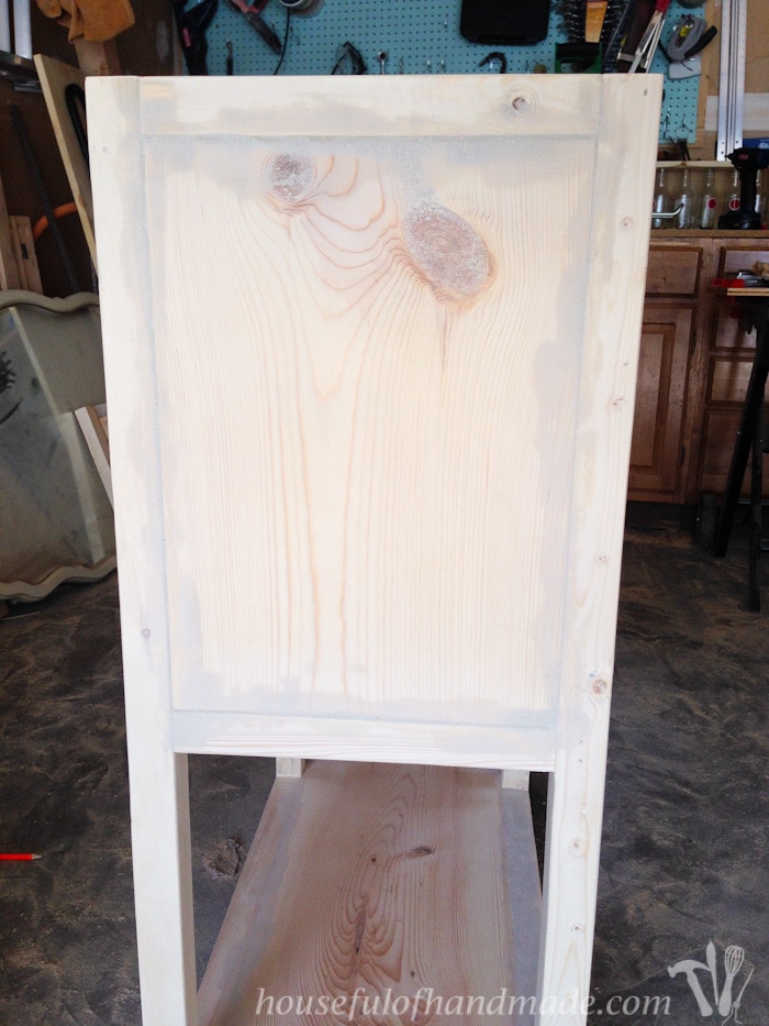 The side of the coffee bar table with gaps filled with wood filler before paint.