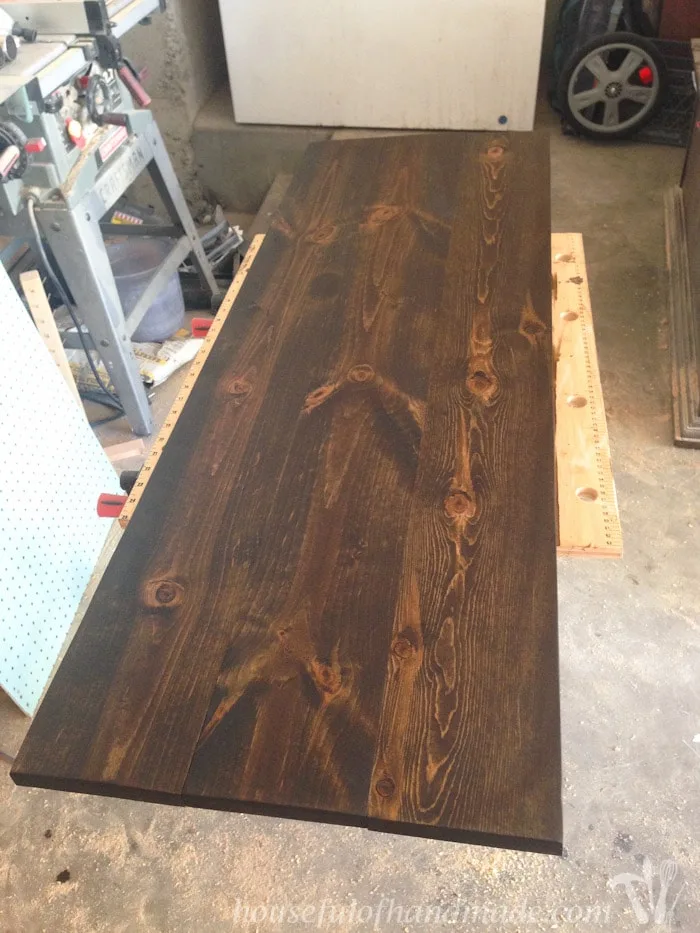 Dark stained console table top.
