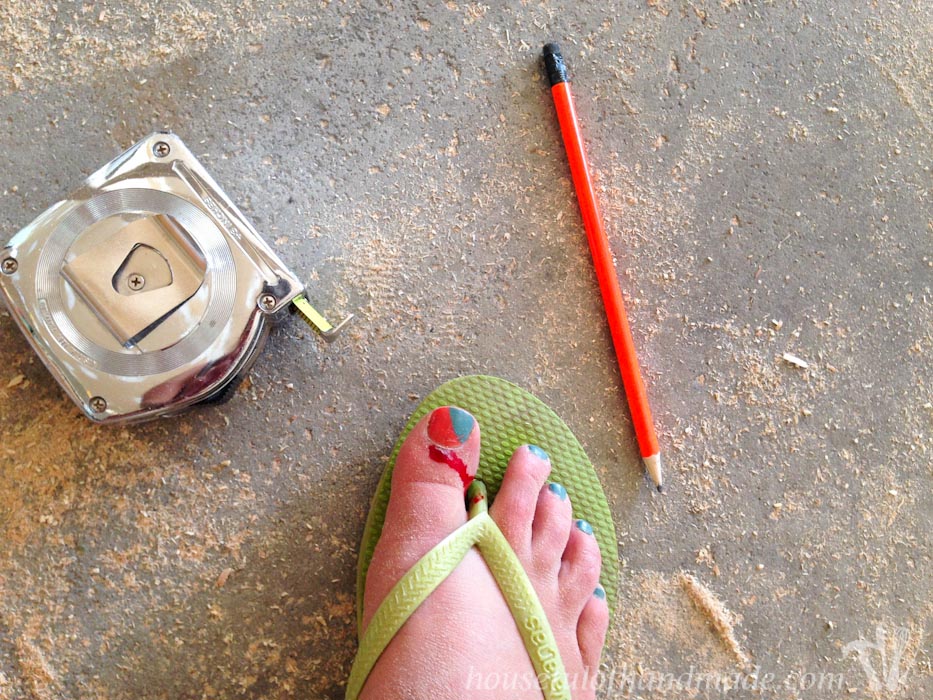 Cut toe in flip flops next to measuring tape and pencil.