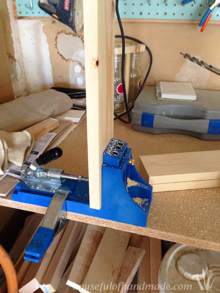 Drilling pocket holes in a 1x4 with a Kreg jig. 