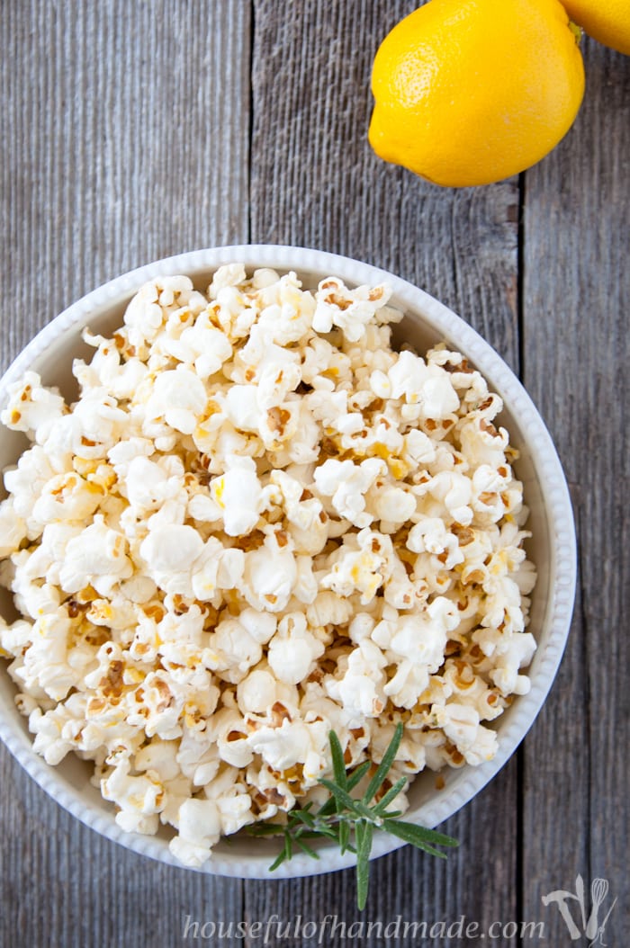 This popcorn is awesome! Brighten up your favorite snack with fresh herbs and citrus. This Lemon Rosemary Popcorn is the perfect combination for a light and airy treat. | Housefulofhandmade.com
