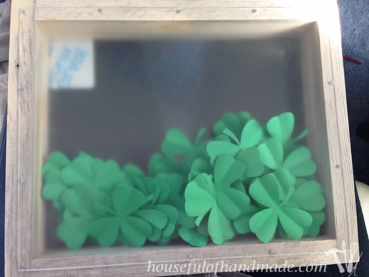 Made a beautiful shadow box full of clovers for a fun St. Patrick's Day shadow box decor idea. See if you can find the 1 4 leaf clover in the bunch. 