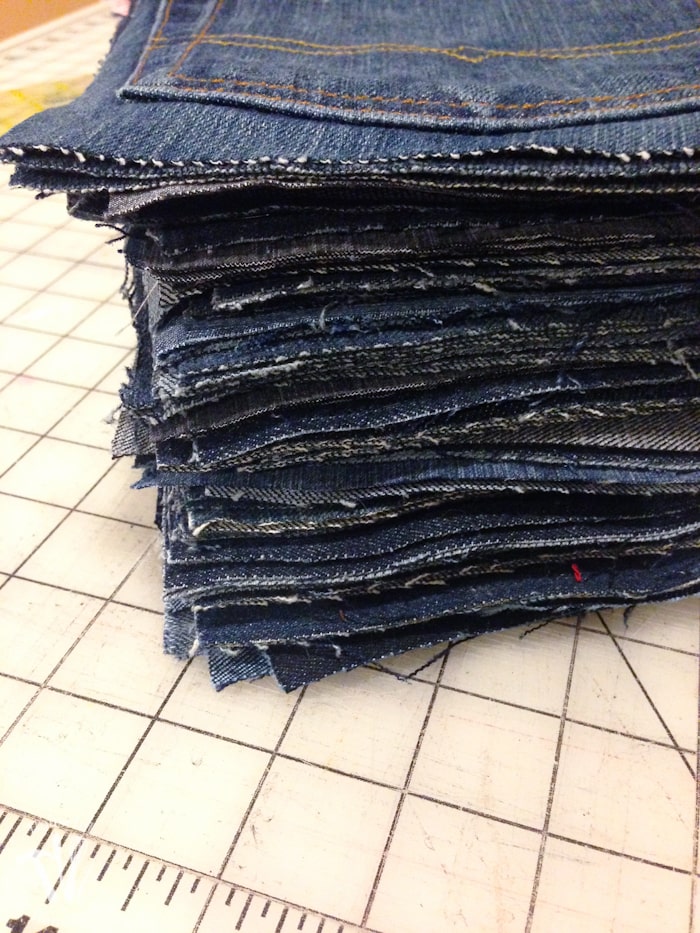 squares of jeans stacked on table for a  Water-resistant upcycled jeans picnic blanket 