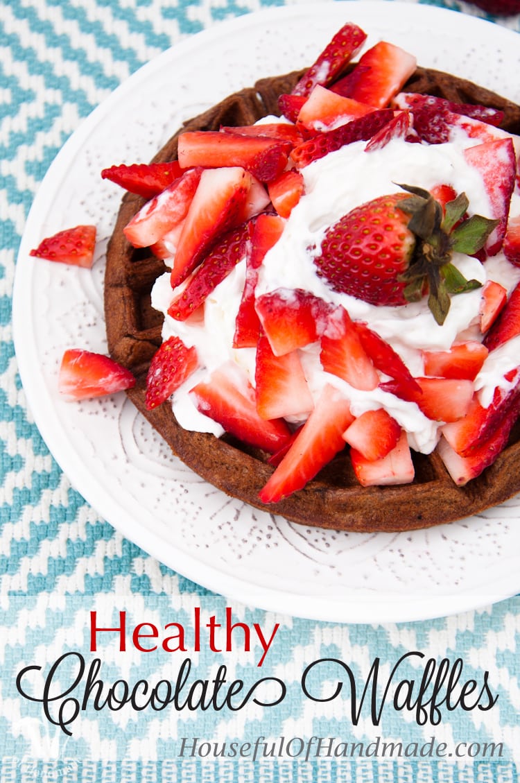 This is the best breakfast ever! Celebrate the weekend with these Healthy Chocolate Waffles covered with a mountain of whipped cream and strawberries. | Housefulofhandmade.com