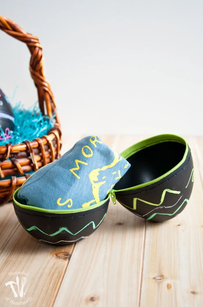 Turn boring decorative eggs into a jumbo chalkboard zipper Easter eggs to fill with clothes or toys. A simple and fun DIY for the perfect Easter basket! | Housefulofhandmade.com