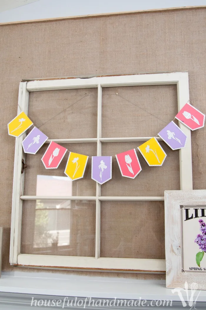 I love using banners to decorate. Create a beautiful spring flower & book page banner with this tutorial and free digital cut file. | Housefulofhandmade.com