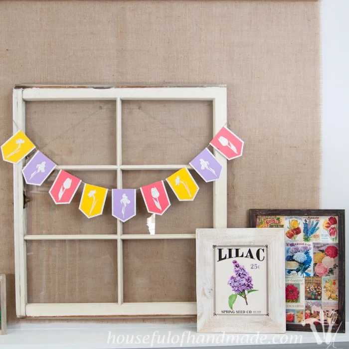 I love using banners to decorate. Create a beautiful spring flower & book page banner with this tutorial and free digital cut file. | Housefulofhandmade.com