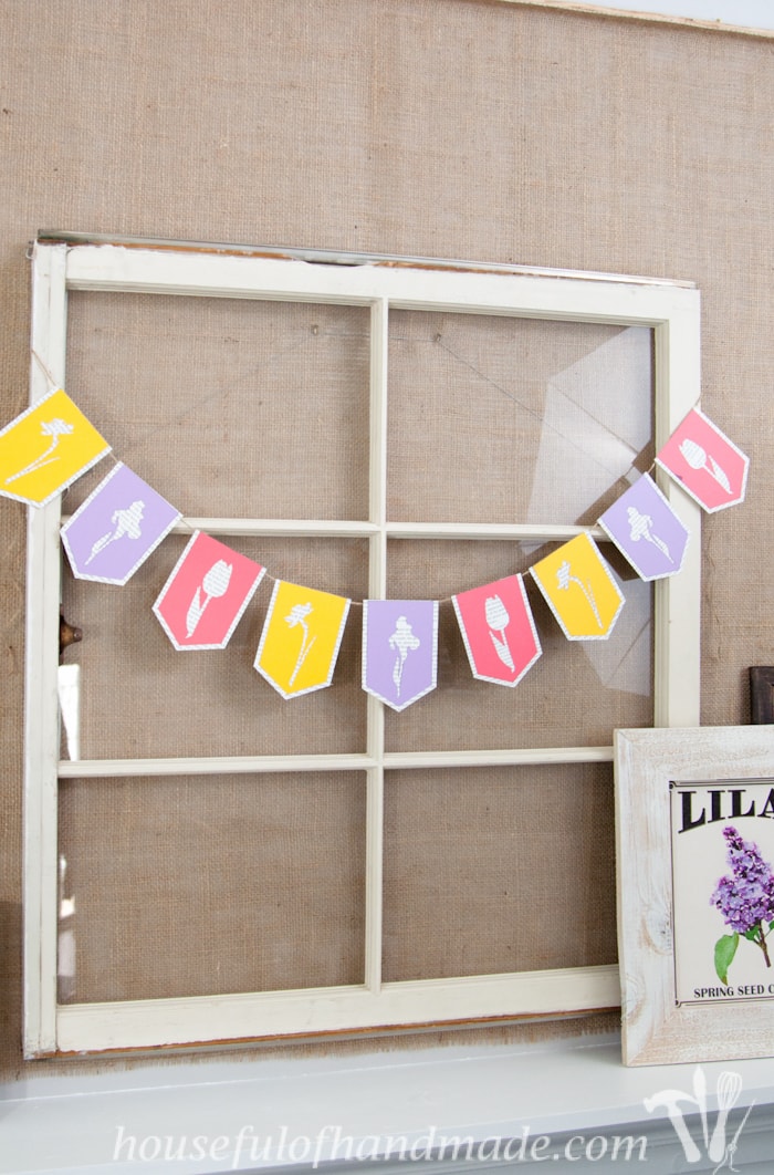 I love using banners to decorate. Create a beautiful spring flower & book page banner with this tutorial and free digital cut file. | Housefulofhandmade.com