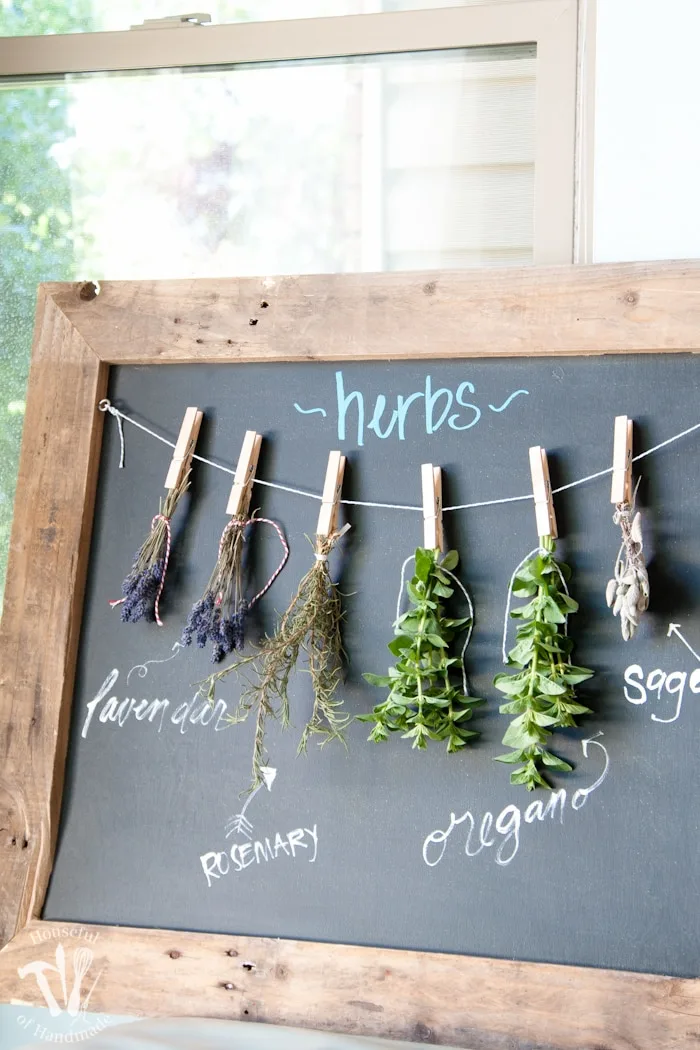 Make drying your herbs a part of your decor with this DIY rustic chalkboard herb drying rack. It's made from an old pallet and makes preserving herbs beautiful. | Housefulofhandmade.com