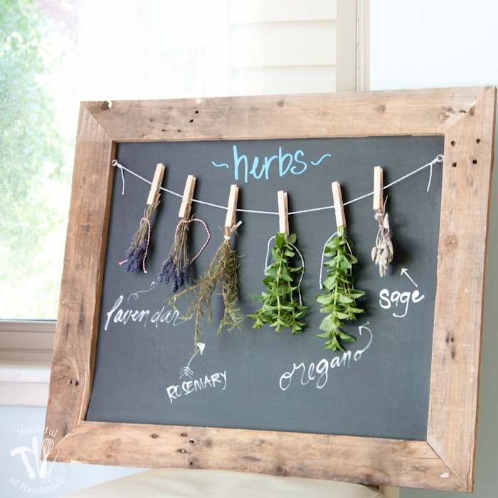 Make drying your herbs a part of your decor with this DIY rustic chalkboard herb drying rack. It's made from an old pallet and makes preserving herbs beautiful. | Housefulofhandmade.com