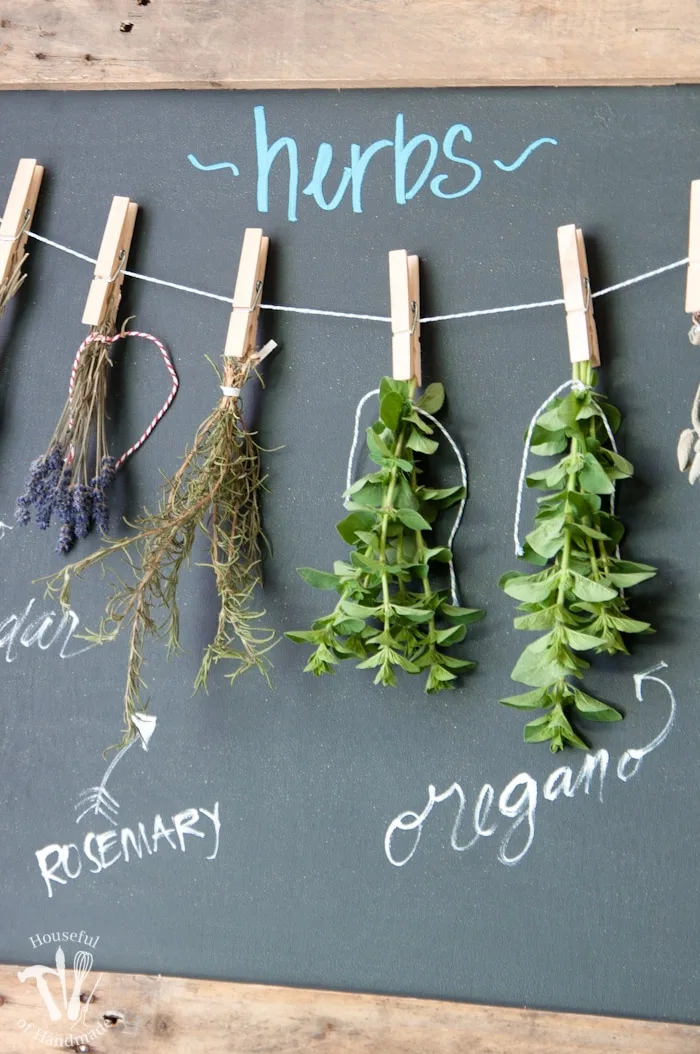 Make drying your herbs a part of your decor with this DIY rustic chalkboard herb drying rack. It's made from an old pallet and makes preserving herbs beautiful. | Housefulofhandmade.com