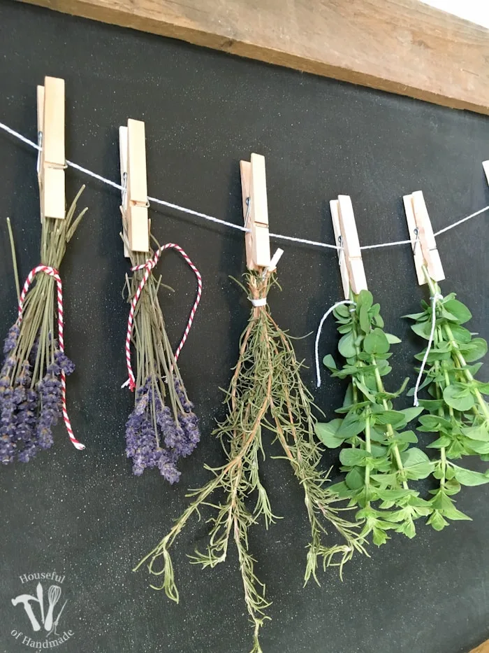 Make drying your herbs a part of your decor with this DIY rustic chalkboard herb drying rack. It's made from an old pallet and makes preserving herbs beautiful. | Housefulofhandmade.com