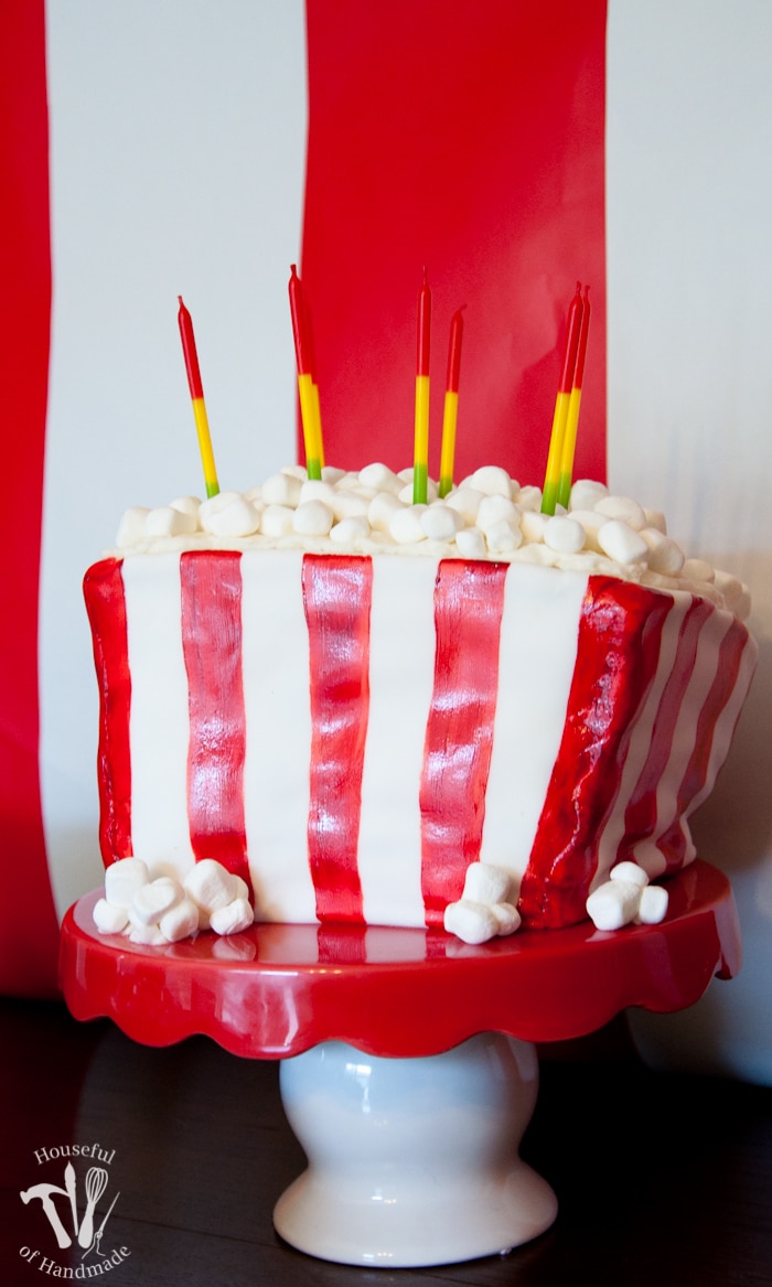Make a cake to look like a movie theatre box of popcorn. It's the perfect cake for a movie theatre themed birthday party. Tutorial at Housefulofhandmade.com