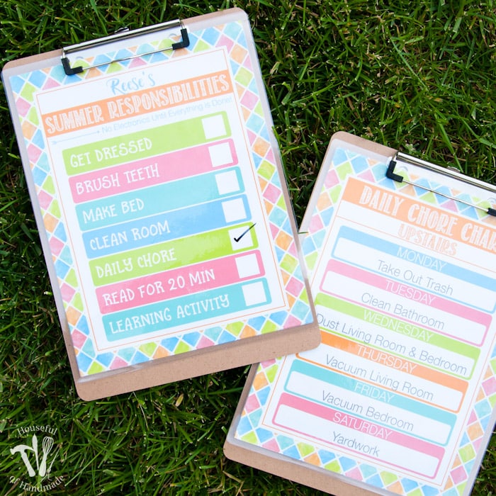 two clipboards on grass with free printable summer chore charts attached to clipboards