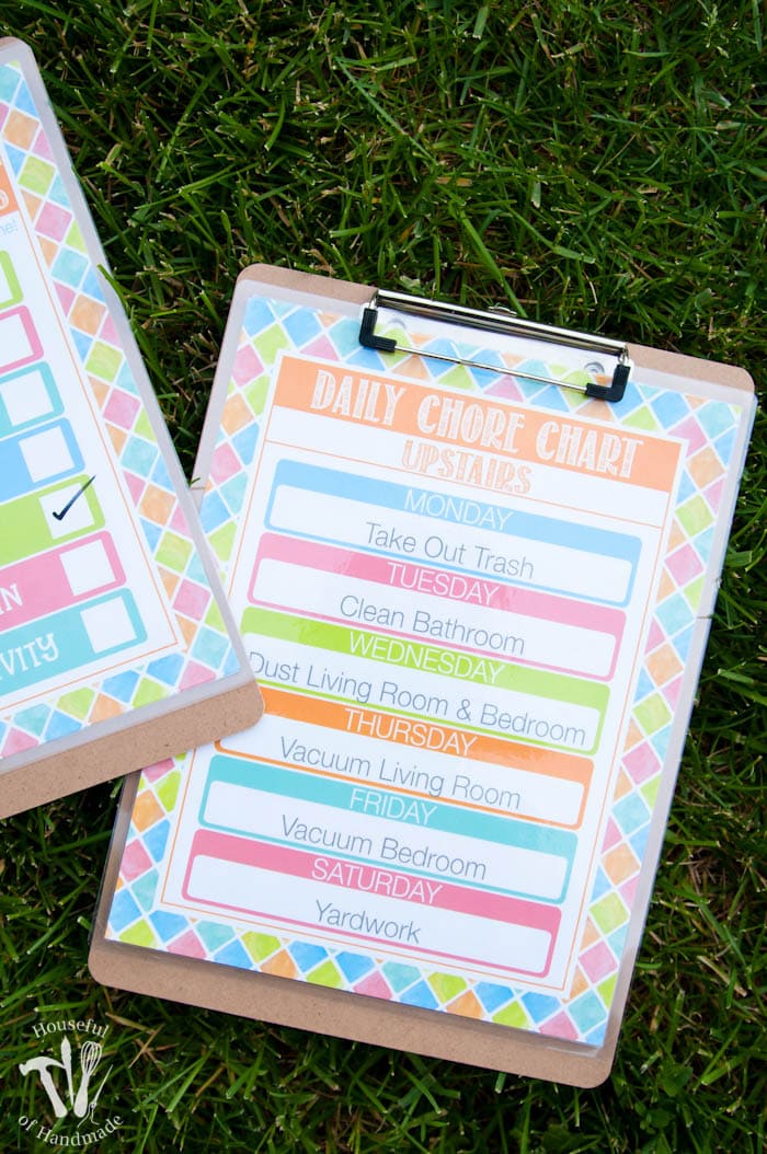 free summer printable chore chart shown on clipboard on grass