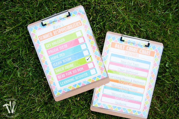 set of two clipboards shown on grass with free printable summer chore charts attached