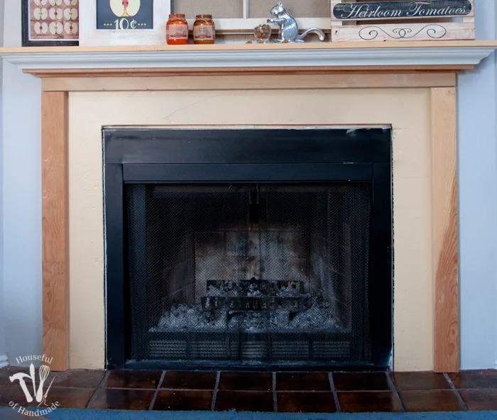 I love this vintage inspired farmhouse fireplace. DIY your own fireplace with new white hexagon tile on a budget. Love the white tiles and gray grout. Farmhouse fireplace reveal from Housefulofhandmade.com