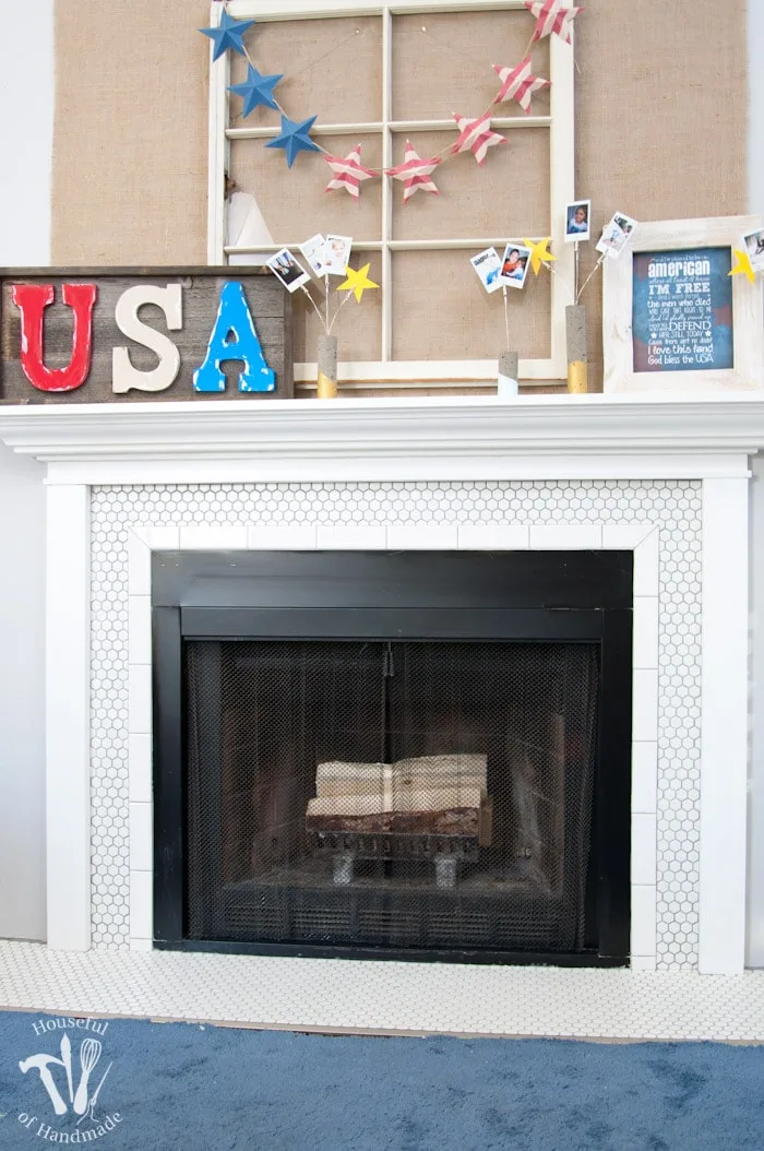 I love this vintage inspired farmhouse fireplace. DIY your own fireplace with new white hexagon tile on a budget. Love the white tiles and gray grout. Farmhouse fireplace reveal from Housefulofhandmade.com