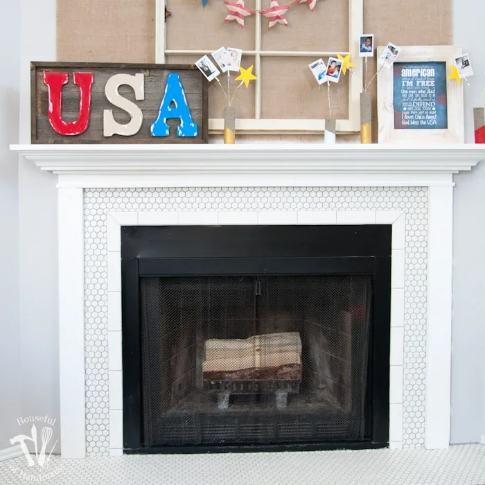 I love this vintage inspired farmhouse fireplace. DIY your own fireplace with new white hexagon tile on a budget. Love the white tiles and gray grout. Farmhouse fireplace reveal from Housefulofhandmade.com