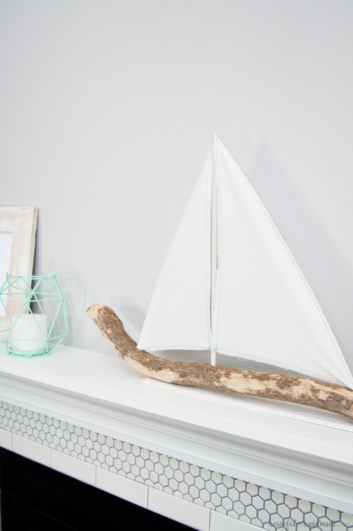 I love coastal decor! If you've ever skipped making your favorite driftwood project because you don't live by the ocean, no need for that anymore. Check out the tutorial for this DIY driftwood sailboat decor and find out where she found driftwood in a land locked state. | Housefulofhandmade.com