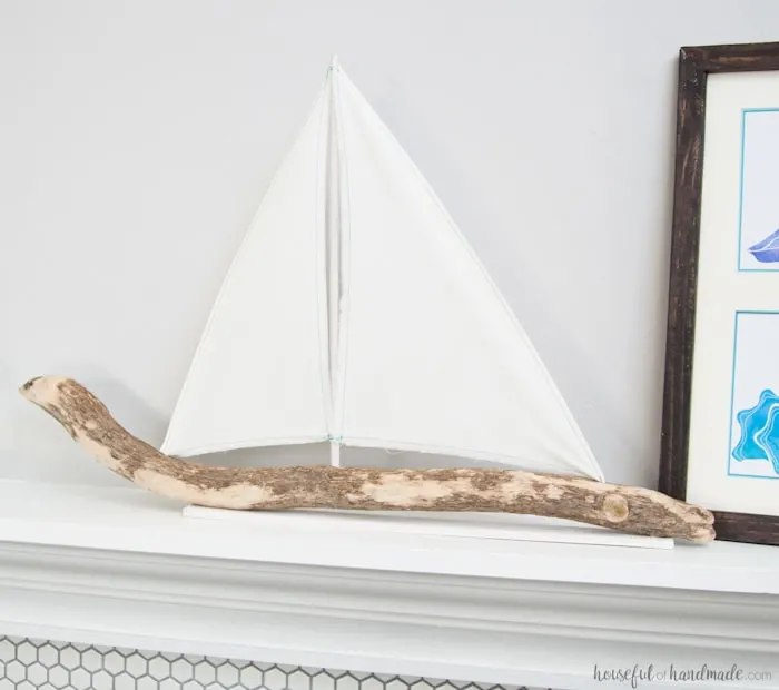 I love coastal decor! If you've ever skipped making your favorite driftwood project because you don't live by the ocean, no need for that anymore. Check out the tutorial for this DIY driftwood sailboat decor and find out where she found driftwood in a land locked state. | Housefulofhandmade.com