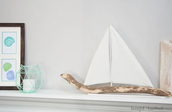 I love coastal decor! If you've ever skipped making your favorite driftwood project because you don't live by the ocean, no need for that anymore. Check out the tutorial for this DIY driftwood sailboat decor and find out where she found driftwood in a land locked state. | Housefulofhandmade.com