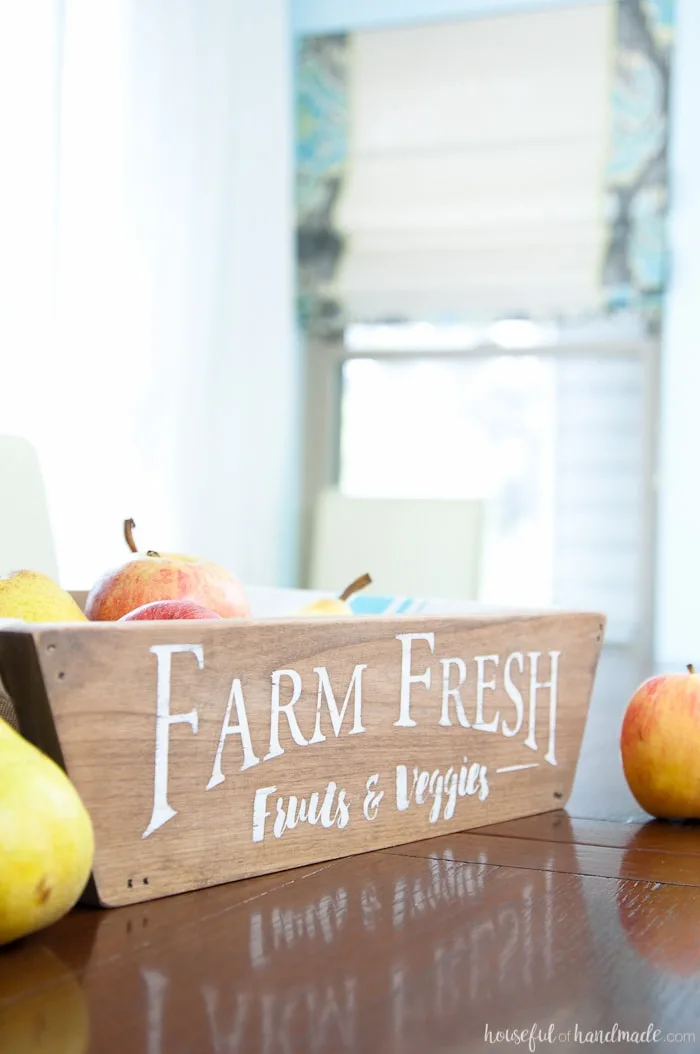 This is the most beautiful way to hold fruits and vegetables on the counter! This easy to make DIY farmhouse style produce basket is a fun twist on a fruit crate. Perfect fall centerpiece to display all the produce from your garden. | Housefulofhandmade.com