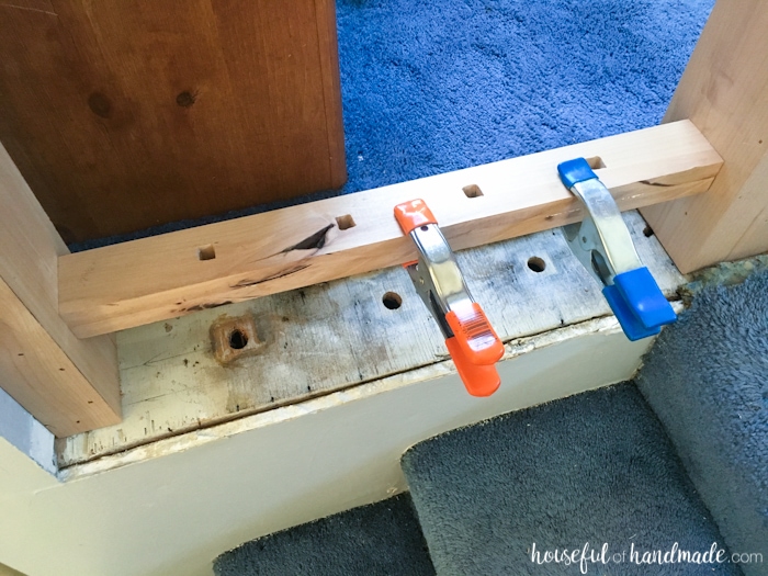 rustic diy railing shown with clamps