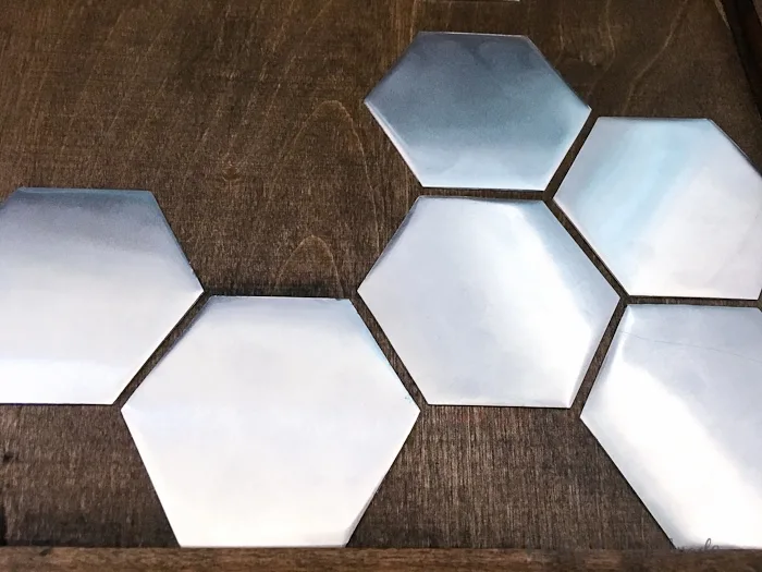 I love this idea for art! Use a combination of wood and metal to make a statement home decor piece. This DIY metal hexagon wall art is the perfect way to add design to your home on a budget. | Housefulofhandmade.com