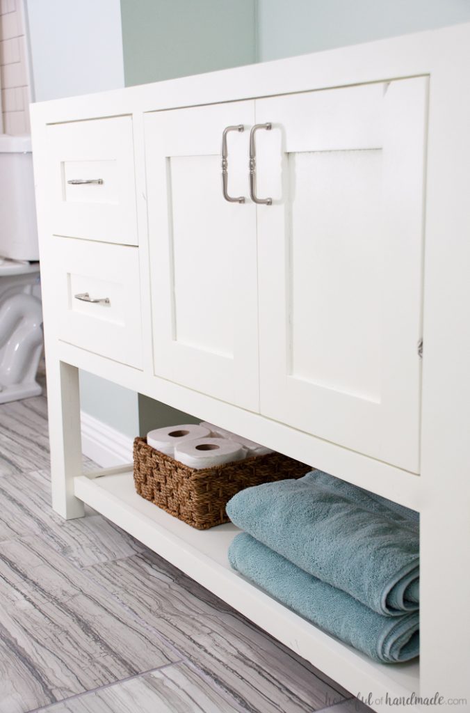 With a little bit of woodworking experience you can build your own bathroom vanity. Build an 8' double vanity for less than $300 for a budget friendly DIY renovation. Get the free plans for this mission style open shelf bathroom vanity from Housefulofhandmade.com