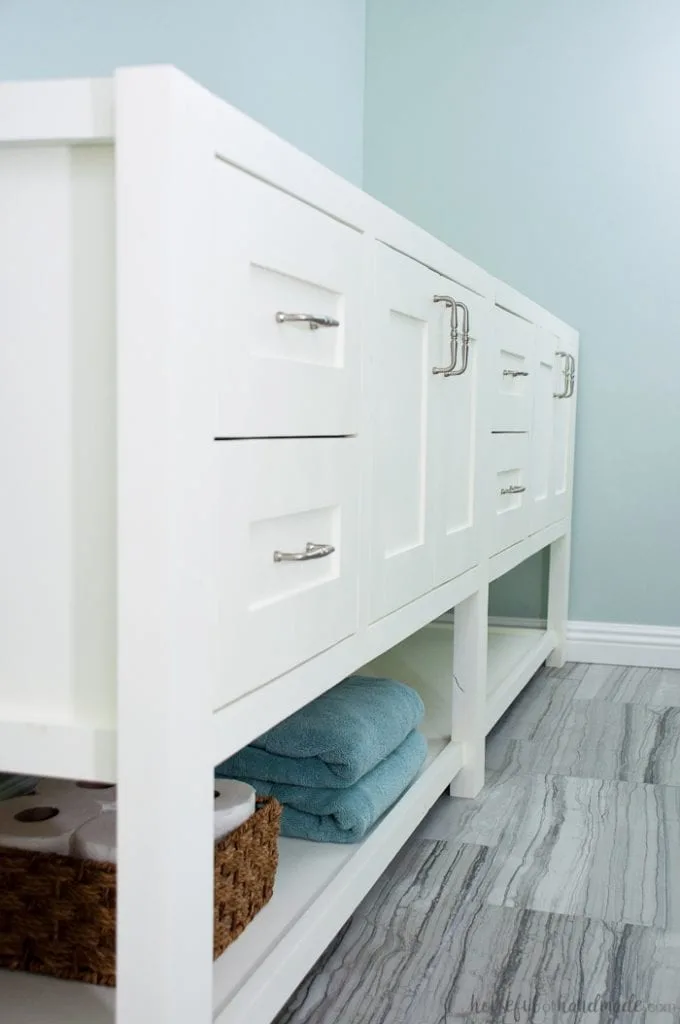 8' long white bathroom vanity that looks like a piece of furniture. 