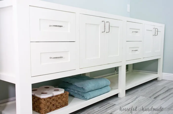 With a little bit of woodworking experience you can build your own bathroom vanity. Build an 8' double vanity for less than $300 for a budget friendly DIY renovation. Get the free plans for this mission style open shelf bathroom vanity from Housefulofhandmade.com