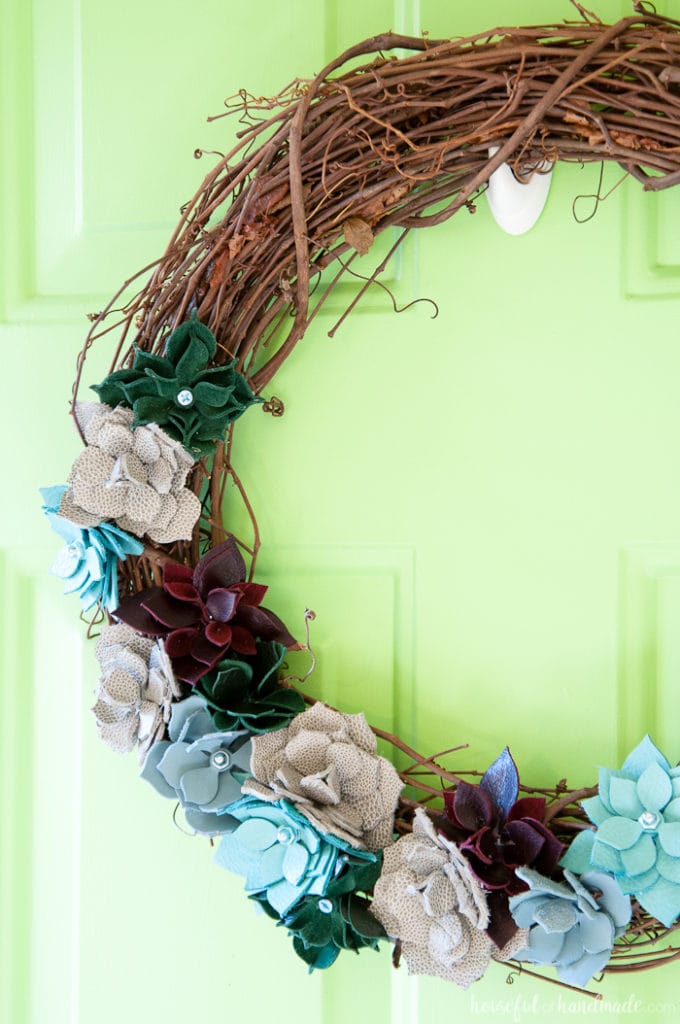 This wreath is so beautiful! I love the leather faux succulents. Use colorful pieces of leather and nuts & bolts to make a rustic industrial DIY leather succulent wreath. | Housefulofhandmade.com