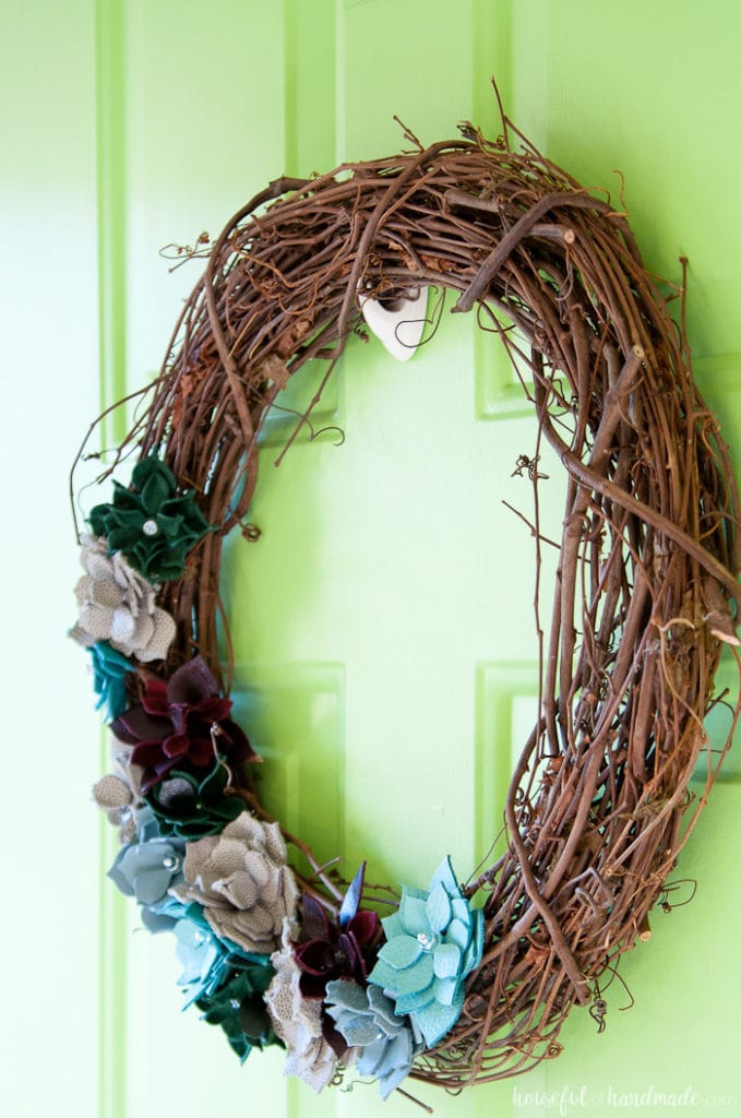 This wreath is so beautiful! I love the leather faux succulents. Use colorful pieces of leather and nuts & bolts to make a rustic industrial DIY leather succulent wreath. | Housefulofhandmade.com
