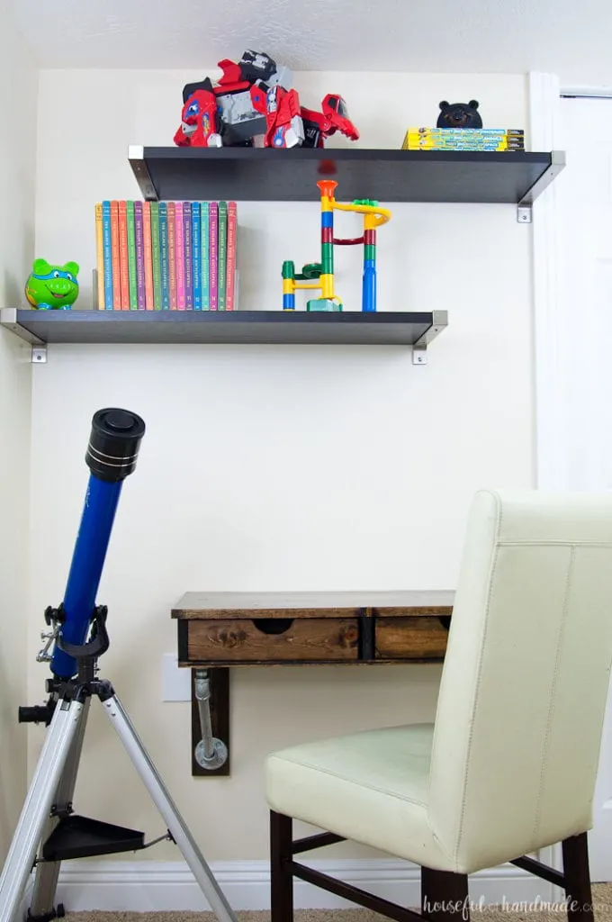 Wall mounted desk with inset drawer fronts and no drawer pulls. 